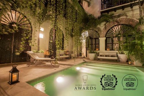 photo of a pool at a hotel boutique Cartagena with stone and brick archways behind it