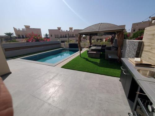 Luxury 4-Bedroom Villa with private swimming pool near Al Hamra Mall Luxury 4-Bedroom Villa with private swimming pool near Al Hamra Mall