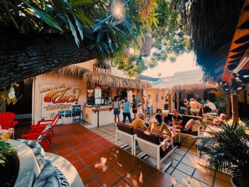 Courtyard at one of the best places to stay in the Cartagena Walled City with people sitting in chairs and talking.