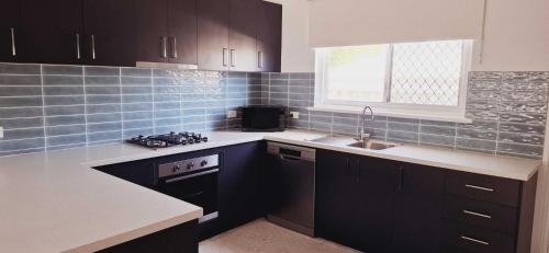 Kitchen, Inviting Stay Close to Rockingham and Palm Beach - Hosted by Canstay in Rockingham Kitchen, Inviting Stay Close to Rockingham and Palm Beach - Hosted by Canstay in Rockingham