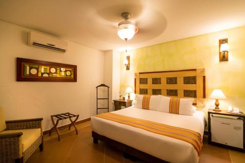 Room with bed and dresser at one of the best hotels in Cartagena Old City