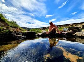 Hótel Laugarhóll with natural hot spring، فندق في Laugarholl