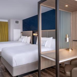 Queen Suite with Two Queen Beds, Partial Ocean View, Trundle Sofa and Balcony