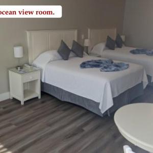 Street view. 2 queen beds. Designated outdoor patio. Poolside Building.