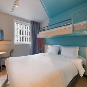 Small triple room with two single beds and a bunk bed