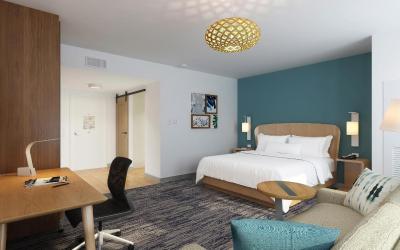 Standard guest room with king bed sofa bed and city view