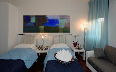 Camera Matrimoniale/Doppia con Letti Singoli con Bagno in Comune