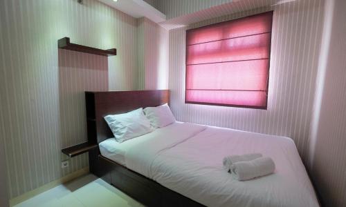 Homey and Relaxing 2BR Green Pramuka Apartment By Travelio