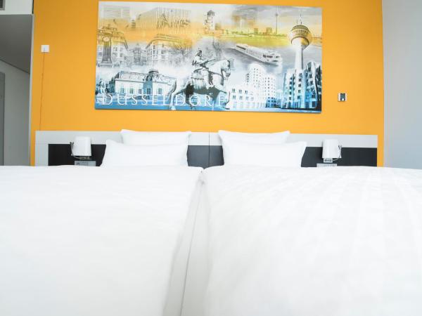 Carathotel Düsseldorf City : photo 1 de la chambre chambre double ou lits jumeaux supérieure