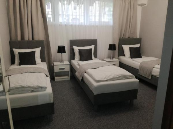 City Rooms Szczecin : photo 1 de la chambre chambre triple classique