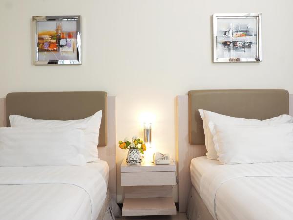 d'primahotel Melawai - Blok M : photo 8 de la chambre chambre deluxe double ou lits jumeaux