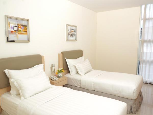 d'primahotel Melawai - Blok M : photo 9 de la chambre chambre deluxe double ou lits jumeaux