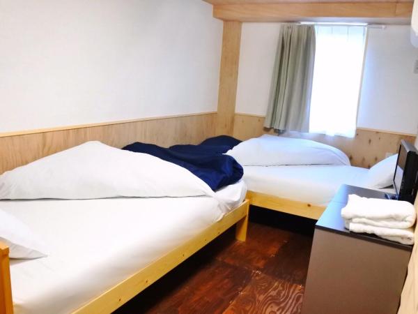 SappoLodge : photo 4 de la chambre chambre lits jumeaux avec salle de bains