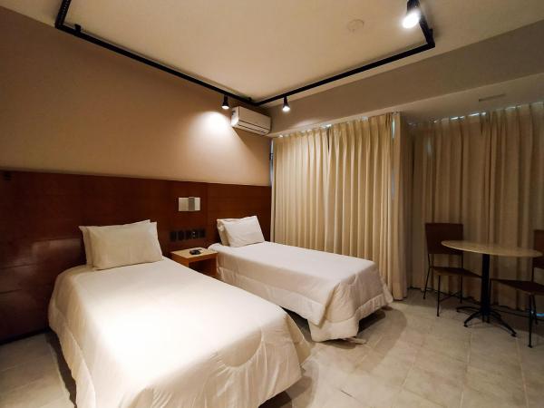 Savassi Village : photo 2 de la chambre chambre double ou lits jumeaux deluxe - vue sur ville