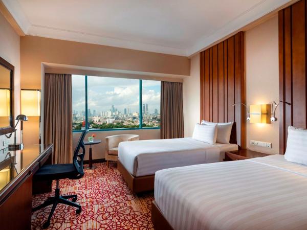 Hotel Ciputra Jakarta managed by Swiss-Belhotel International : photo 1 de la chambre hébergement deluxe premium lits jumeaux