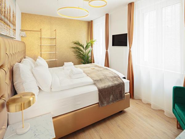 EH Apartments Merkur : photo 8 de la chambre suite supérieure lit king-size