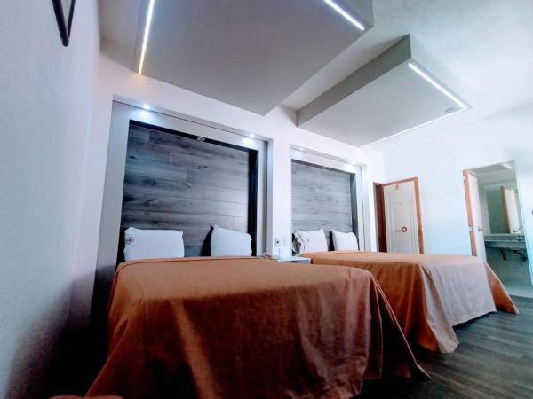 Hotel Mina : photo 2 de la chambre chambre avec 2 grands lits queen-size