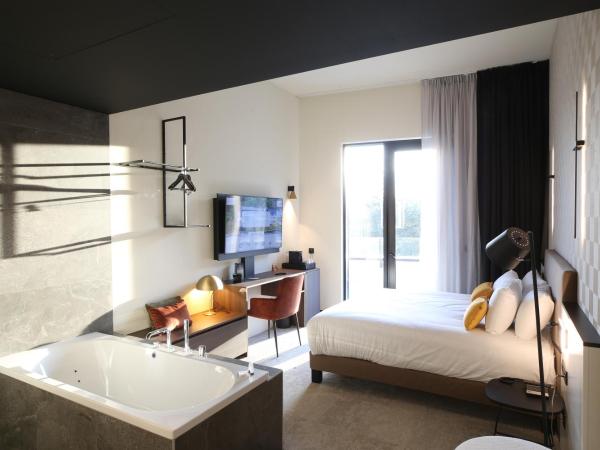 Mercure Namur Hotel : photo 8 de la chambre suite junior lit king-size avec baignoire spa - accès à la terrasse - vue sur fleuve