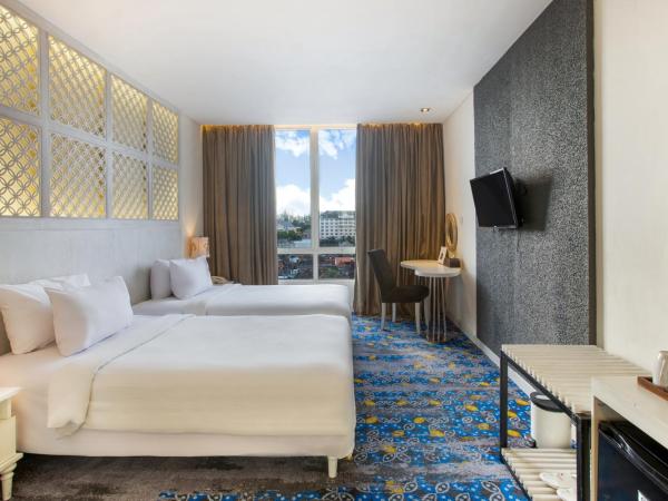 Jambuluwuk Malioboro Hotel Yogyakarta : photo 1 de la chambre chambre lits jumeaux deluxe avec lit d'appoint