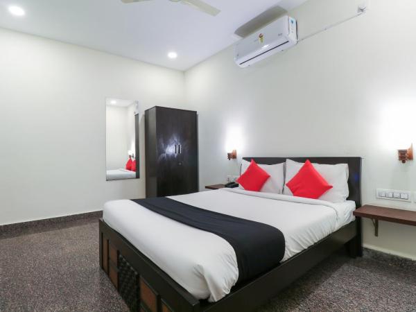 Capital O GN Suites : photo 1 de la chambre chambre double standard