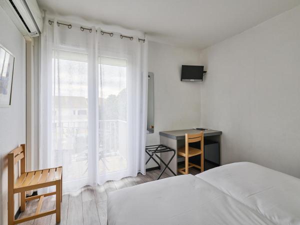 Hôtel Les Mimosas : photo 1 de la chambre chambre lits jumeaux confort avec balcon et climatisation - côté rue