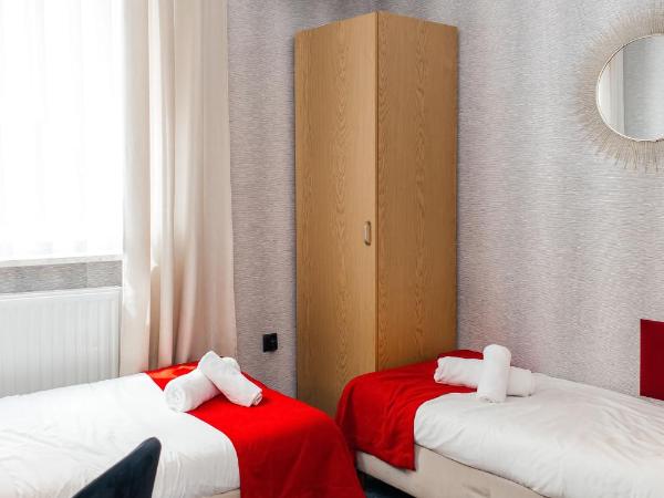 Elegant Apartments : photo 2 de la chambre chambre lits jumeaux avec salle de bains privative