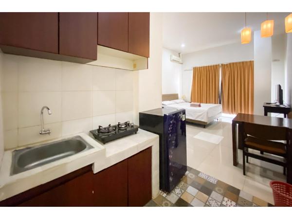 Curves Residence Mitra RedDoorz : photo 5 de la chambre chambre double deluxe