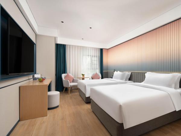 广州番禺万博中心舒与酒店 : photo 2 de la chambre chambre lits jumeaux spacieuse