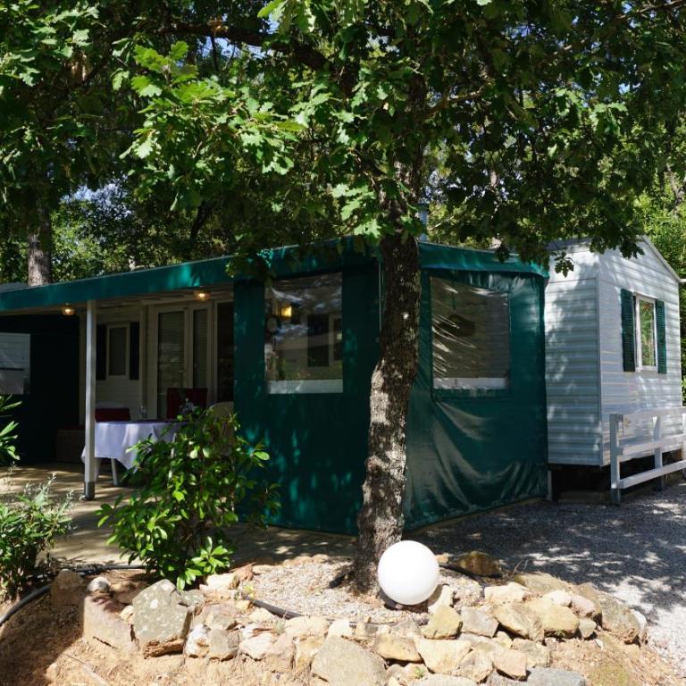 Chalets with kitchen outside at Camping Leï Suves - JoyCasa - Mobile Home - 6