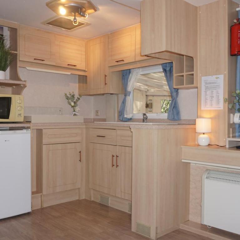 Chalets with kitchen outside at Camping Leï Suves - JoyCasa - Mobile Home - 5