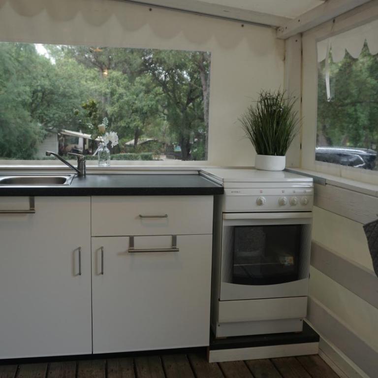 Chalets with kitchen outside at Camping Leï Suves - JoyCasa - Mobile Home - 5