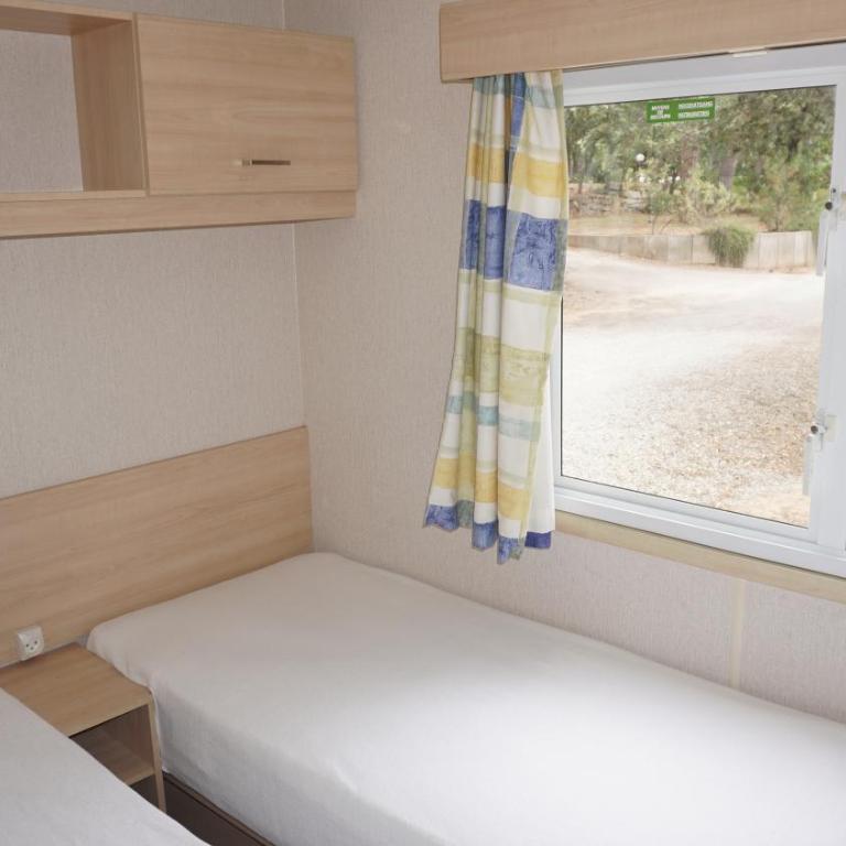Chalets with kitchen outside at Camping Leï Suves - JoyCasa - Mobile Home - 4