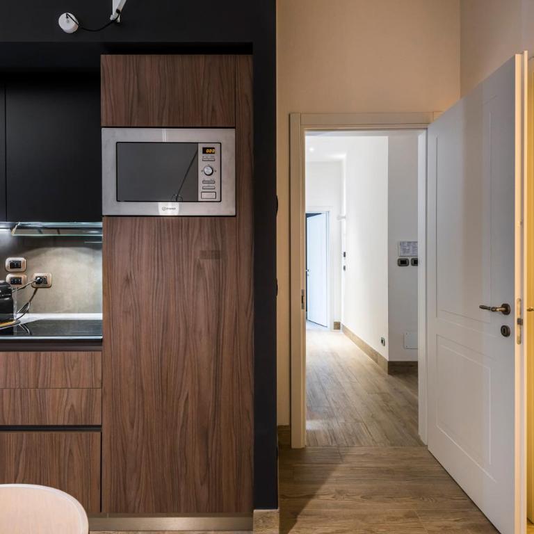 Eco Chic room with sofa bed and kitchen by Design Club Collection - One-Bedroom Apartment - 3