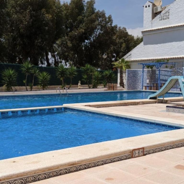Charming 3-Bedroom House with Shared Pool in Punta Prima, Torrevieja - Vacation Home - 1
