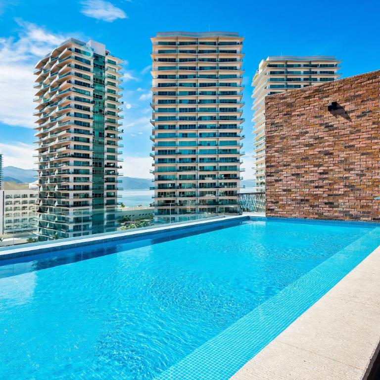 5th-floor condo with partial ocean views, heated pool, sauna, gym, balcony, W/D - Vacation Home - 27