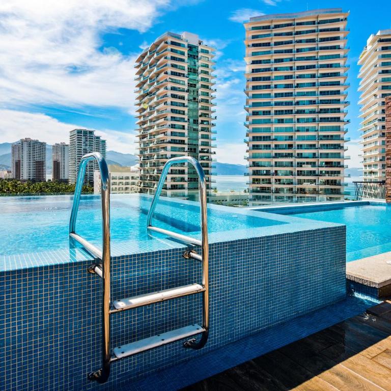 5th-floor condo with partial ocean views, heated pool, sauna, gym, balcony, W/D - Vacation Home - 28