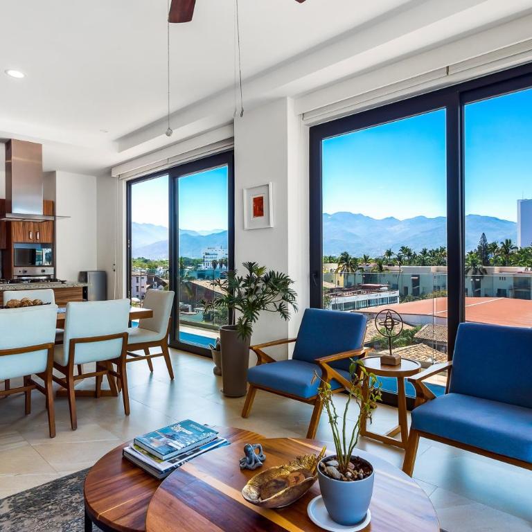 5th-floor condo with partial ocean views, heated pool, sauna, gym, balcony, W/D - Vacation Home - 5