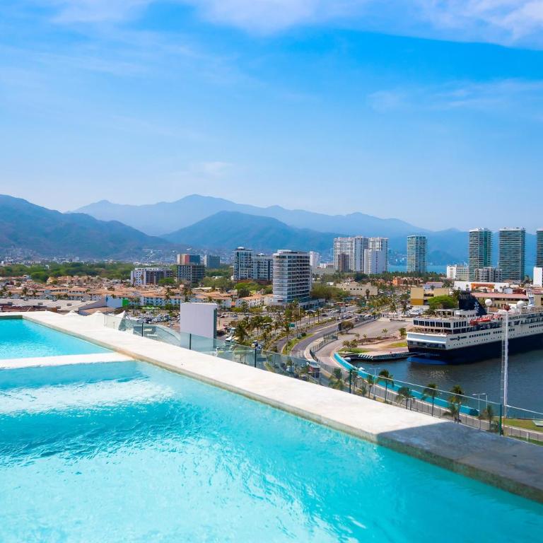 Resort condo with balcony, views, rooftop pool, gym, & full kitchen - Vacation Home - 24