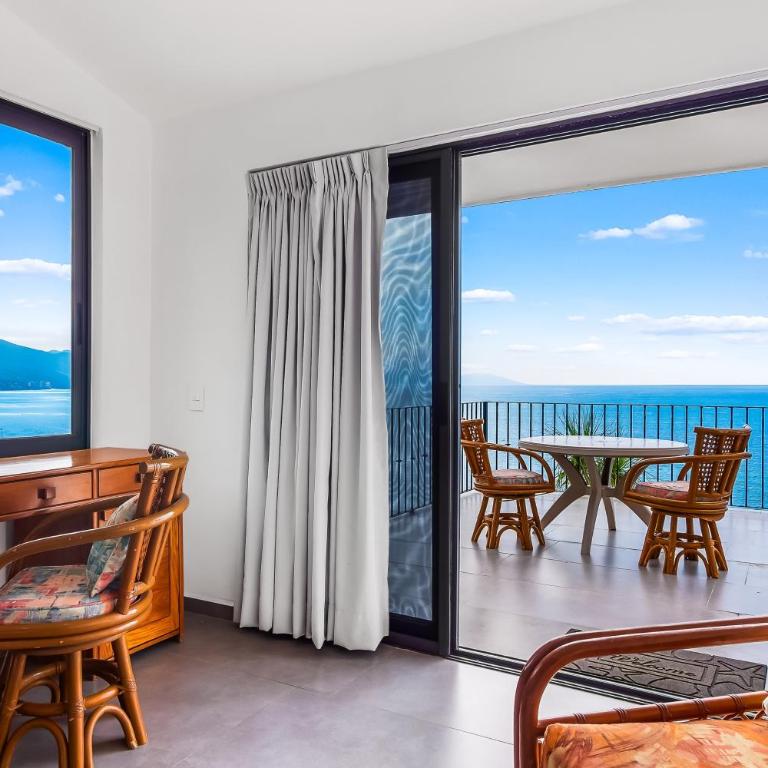 Bright ocean-view 2-story condo near beach with pool, balcony & full kitchen - Vacation Home - 5
