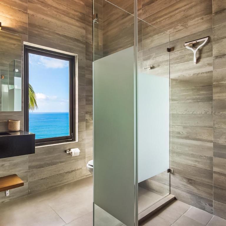 Bright ocean-view 2-story condo near beach with pool, balcony & full kitchen - Vacation Home - 24