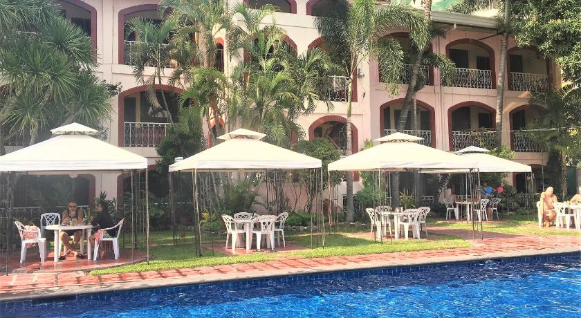 a patio area with a pool, chairs, and umbrellas, Orchid Inn Resort in Angeles / Clark