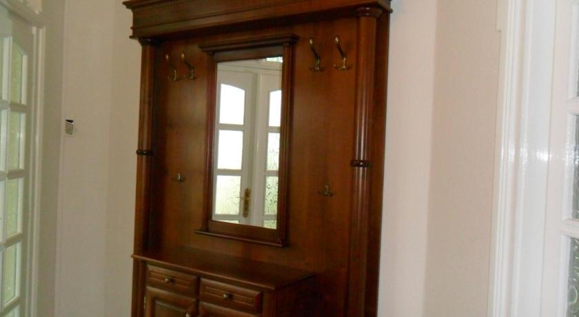 a wooden cabinet sitting in front of a window, Villa Gardena Gardony in Gárdony