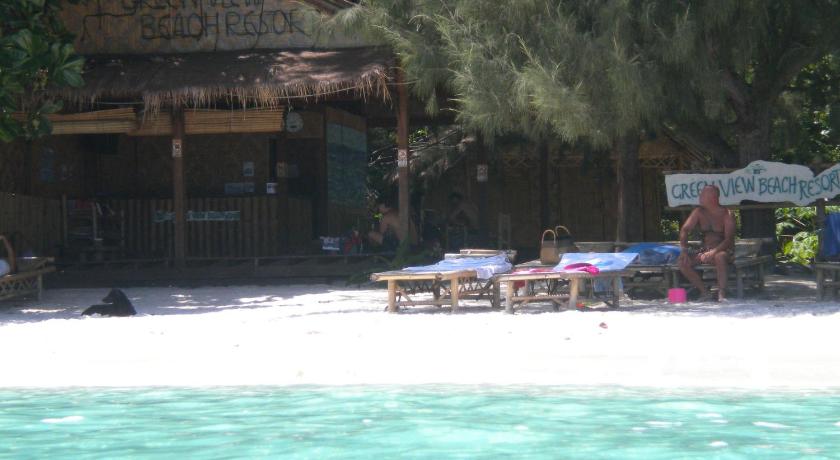 a beach area with a pool, chairs, and a beach umbrella, Green View Beach Resort in Ko Lipe