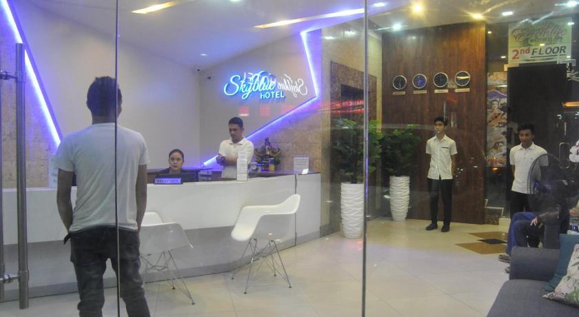 a man standing in front of a bar in a store, Skyblue Hotel in Cebu