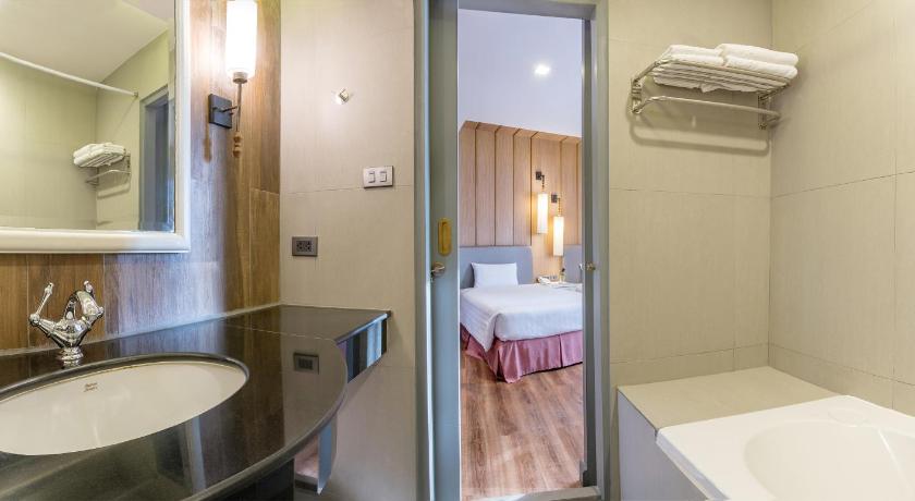 a bathroom with a sink and a mirror, Royal Rattanakosin Hotel (SHA Extra Plus) in Bangkok