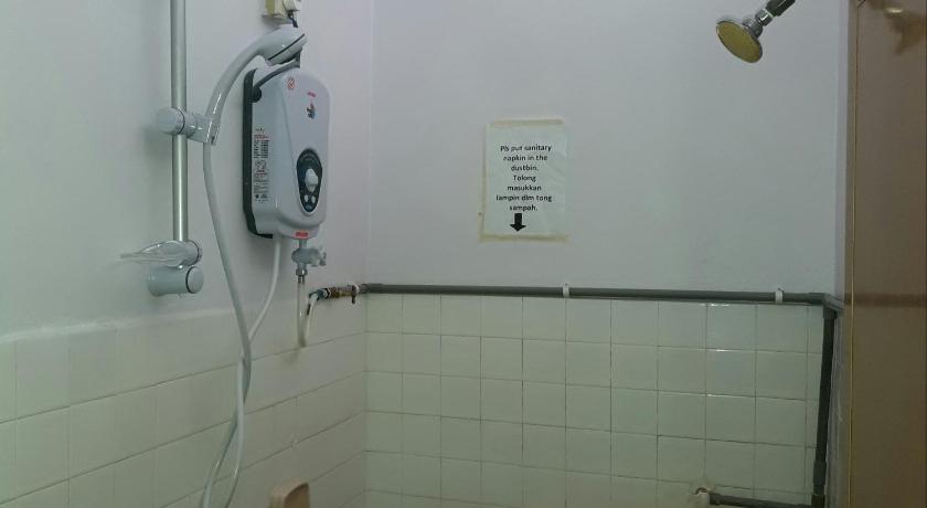 a bathroom with a white wall and a white toilet, Wira Homestay Sungai Petani in Sungai Petani