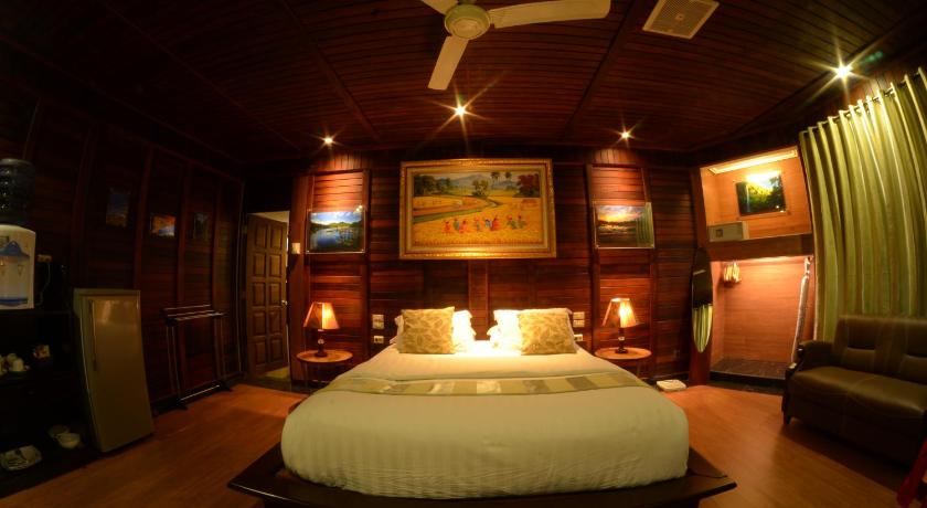 a room with a bed and a fireplace, Highland Resort & Nature Tours in Manado