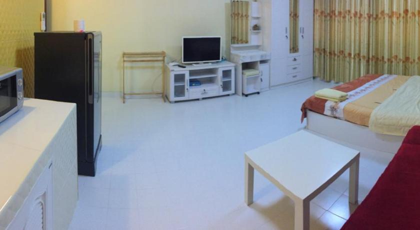 a living room filled with furniture and a tv, SK Muangthongthani Apartment in Bangkok