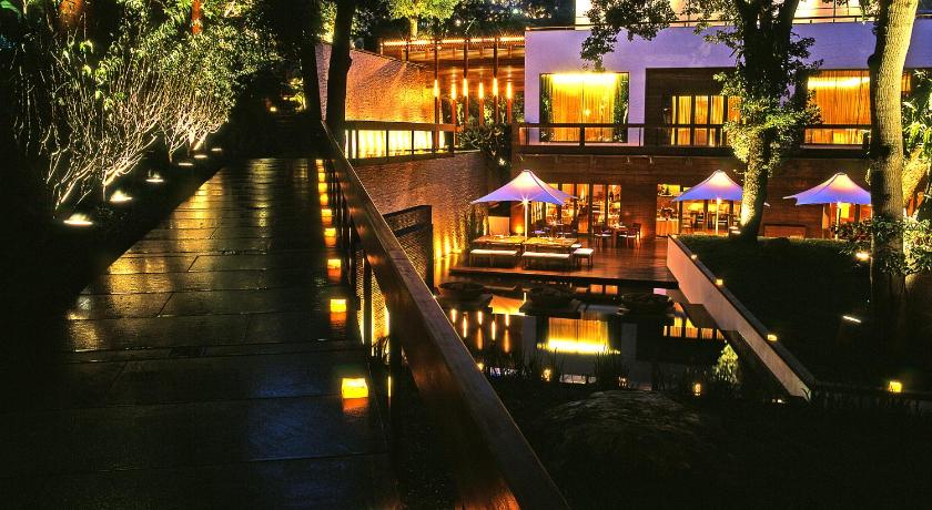 a row of tables with umbrellas in the water, Villa 32 in Taipei