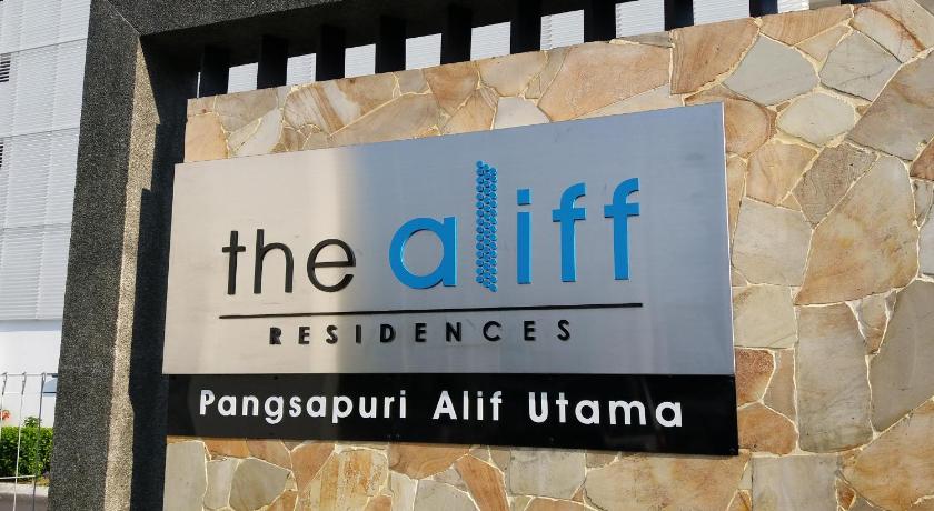 a street sign on a brick wall in front of a building, The Aliff Residences in Johor Bahru